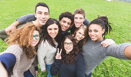 college students holding camera taking a selfie