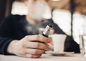 man holding vape pen