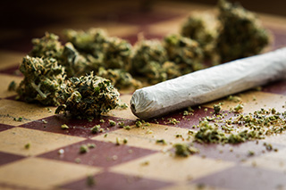 marijuana and joint on a checkered board