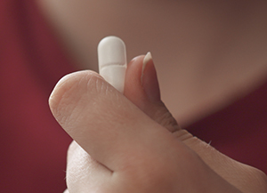 person holding pill