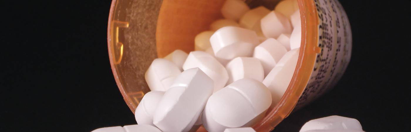 Pills fall out of a bottle