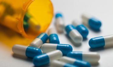 Pills spill out of a bottle