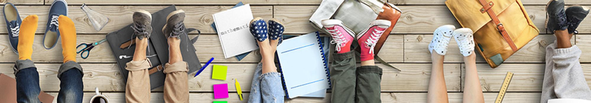 group of college students backpacks, legs, and books
