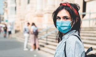 female student wearing mask on campus