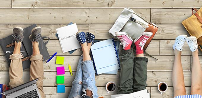 group of college students backpacks, legs, and books